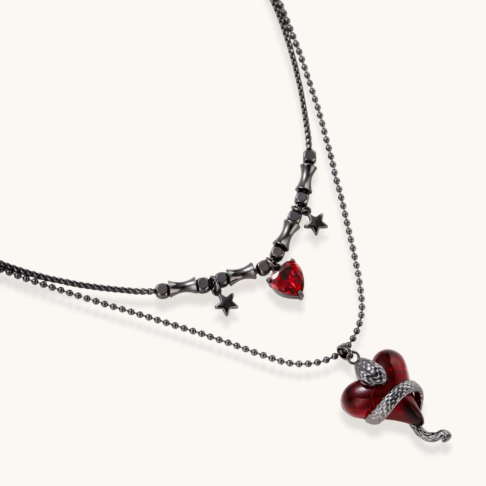 Gothic jewelry set with asymmetrical black metal earrings featuring red crescent moons, stars, and layered necklaces with heart pendants